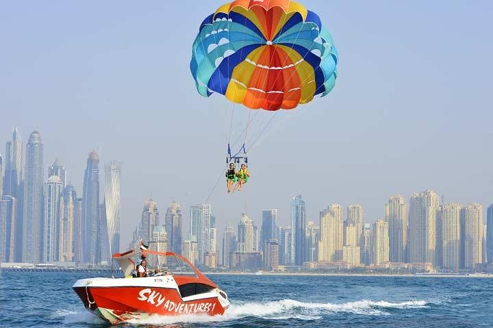 Soar above Dubai Marina for breathtaking views of the skyline Palm Island and iconic landmarks. Experience the serenity of parasailing while floating high above the mesmerizing landscape.